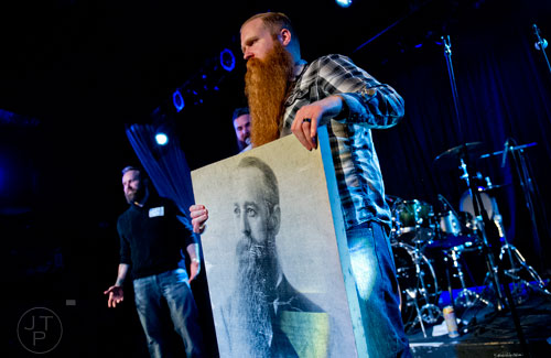 Aaron McCants plays up to the crowd in the Best Grooming competition during the 4th annual Battle of the Beards at Smith's Olde Bar in Atlanta on Saturday, December 13, 2014. 
