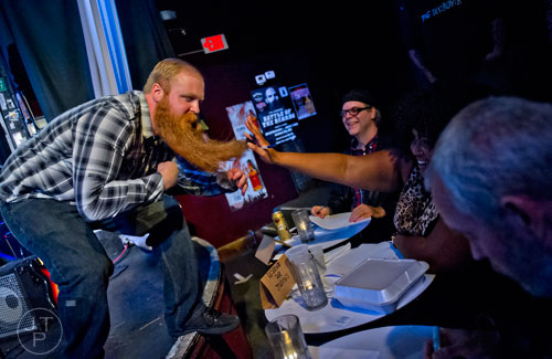 Aaron McCants (left) leans in close for Dulce Sloan and the other judges to get a good look in the Best Grooming competition during the 4th annual Battle of the Beards at Smith's Olde Bar in Atlanta on Saturday, December 13, 2014. 