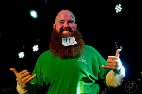 Scott Corcoran plays to the crowd as he competes in the Best Grooming competition during the 4th annual Battle of the Beards at Smith's Olde Bar in Atlanta on Saturday, December 13, 2014. 
