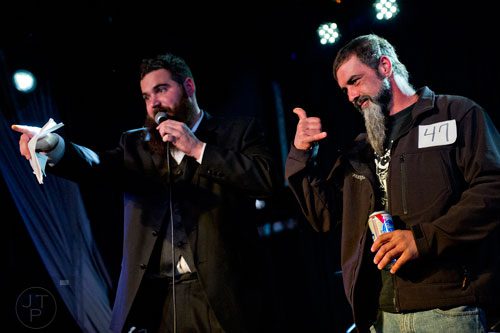 Michael Moon (right) plays to the crowd as he competes in the Best Grooming competition as Mike Albanese emcees during the 4th annual Battle of the Beards at Smith's Olde Bar in Atlanta on Saturday, December 13, 2014.