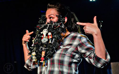 Rachel Berning plays to the crowd as she competes in the Lady Beard competition during the 4th annual Battle of the Beards at Smith's Olde Bar in Atlanta on Saturday, December 13, 2014.