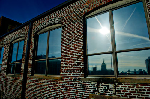 The capital building is reflected in a window near Underground Atlanta in downtown on New Years Day on January 1, 2015.  