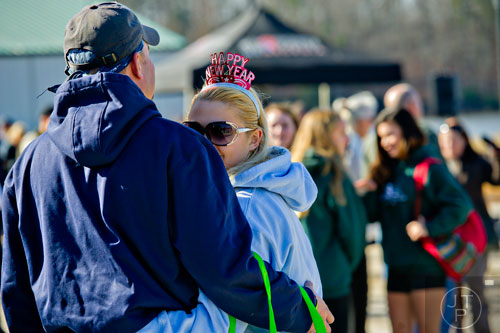 Miranka Van Hintum (right) cuddles up next to Kris Kazecki before jumping into Lake Lanier during the 18th annual Polar Bear Plunge at the Lanier Canoe & Kayak Club in Gainesville on Thursday, January 1, 2015. 