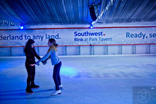 Anabel Panero (left) ice skates with Jo Samuels at the Southwest Rink at Park Tavern in Atlanta on Saturday, January 3, 2015.