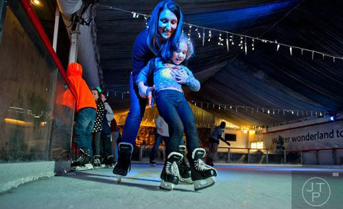 Sloan Reckamp (front) tries to stay on her feet as she skates with her mother Jill at the Southwest Rink at Park Tavern in Atlanta on Saturday, January 3, 2015. 
