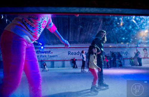 Camille Pacht (right) skates with Emily Grumbolski at the Southwest Rink at Park Tavern in Atlanta on Saturday, January 3, 2015.