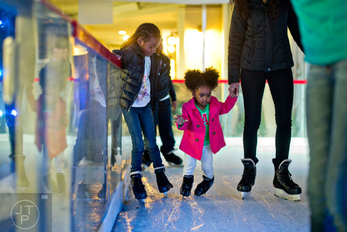 Chloe Beasley (left) and Aminah Jackson skate with thie aunt Zarinah Dennis at the Southwest Rink at Park Tavern in Atlanta on Saturday, January 3, 2015. 