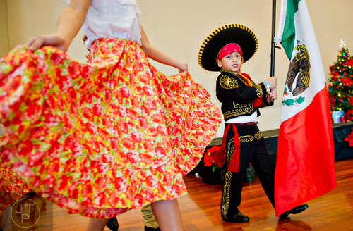 Giann Carlos Parra (right) carries the Mexican flag as he performs with dancers during the Three Kings Day Festival at the Atlanta History Center on Sunday, January 4, 2015. 