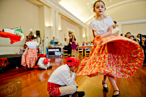 Dariana Reyna (right) dances around Diego Garcia as they perform during the Three Kings Day Festival at the Atlanta History Center on Sunday, January 4, 2015. 