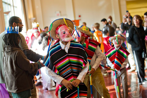 Jose Casas (center) leads dancers through the crowd during the Three Kings Day Festival at the Atlanta History Center on Sunday, January 4, 2015. 