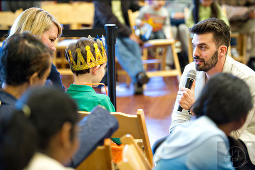 Manolo Alayeto (right) speaks to the crowd as he performs during the Three Kings Day Festival at the Atlanta History Center on Sunday, January 4, 2015.