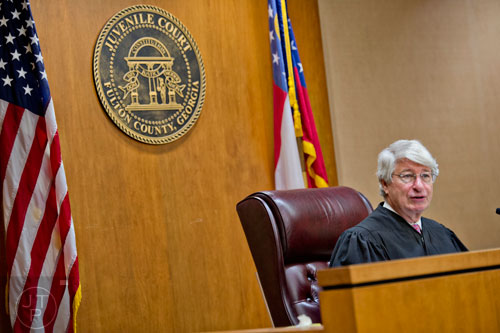 Chief Judge Bradley J. Boyd addresses Michael Majette and his wife Pam during the finalization of the adoption of their three sons at Fulton County Juvenile Court in Atlanta on Monday, December 29, 2014. 