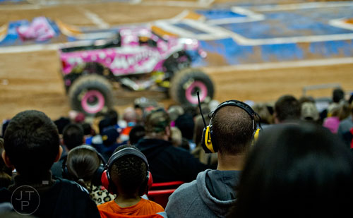 Connor Campbell (left) sits next to his father Paul as they watch Monster Jam at the Georgia Dome in Atlanta on Saturday, January 10, 2015. 