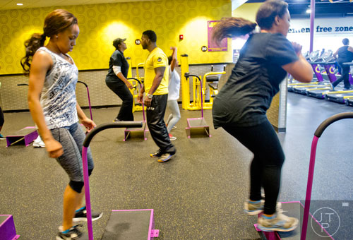 Deon Brown (center) leads a 30 minute circuit class at the Planet Fitness off of Wesley Chapel Rd. in Decatur on Wednesday, January 14, 2015. 