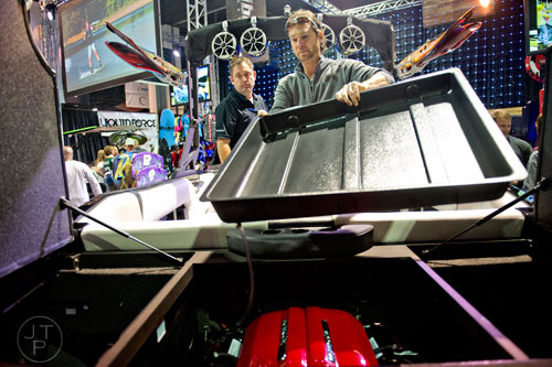 Ben Robinson (left) talks with Josh McAfee as he looks under the hood of a Axis A24 Vandall during the Atlanta Boat Show at the Georgia World Congress Center on Saturday, January 17, 2015. 