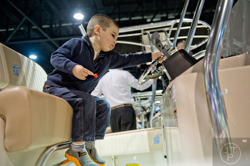 Luke Brown plays at the controls of a Carolina Skiff 23 Ultra Ellite during the Atlanta Boat Show at the Georgia World Congress Center on Saturday, January 17, 2015.