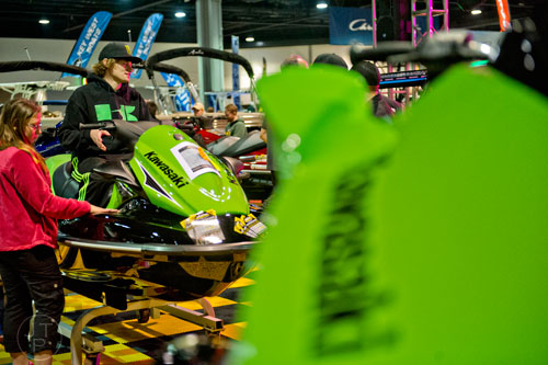 Jesse Pace (left) and her husband Clinton check out a Kawasaki 15F jet ski during the Atlanta Boat Show at the Georgia World Congress Center on Saturday, January 17, 2015. 