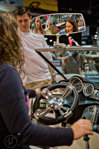 Cathy Farlow (left), Shaun Roberts and his wife Ann check out a MasterCraft X25 during the Atlanta Boat Show at the Georgia World Congress Center on Saturday, January 17, 2015. 