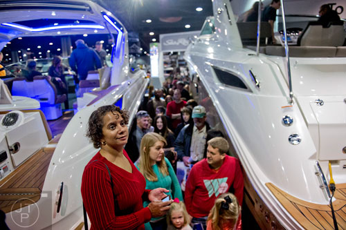 Annette Taylor (left) stands in line to check out the Sea Ray boat display during the Atlanta Boat Show at the Georgia World Congress Center on Saturday, January 17, 2015. 