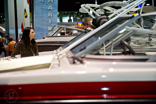 Alaina Levant (left) and Chris Warfield check out one of the hundreds of boats on display during the Atlanta Boat Show at the Georgia World Congress Center on Saturday, January 17, 2015. 