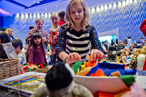 Emma Grovijohn (center) builds a penguin nest during the Party with the Penguins event at the Georgia Aquarium in downtown Atlanta on Saturday, January 17, 2015. 
