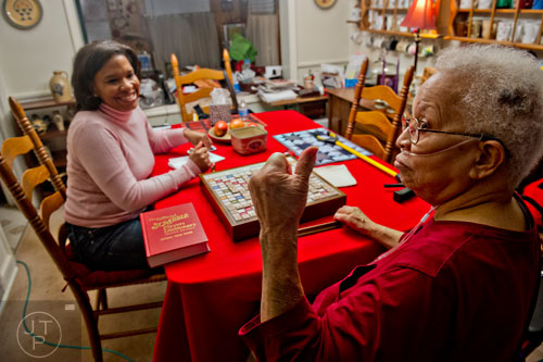Ann Drake (right) gives a thumbs up after beating her daughter Crystal in a game of scrabble at her home in Atlanta on Wednesday, January 14, 2015. 