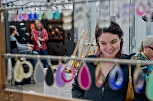 Racheal Borgman (right) looks at earrings designed by Amy Gresens during the Callanwolde Arts Festival in Atlanta on Saturday, January 24, 2015. 
