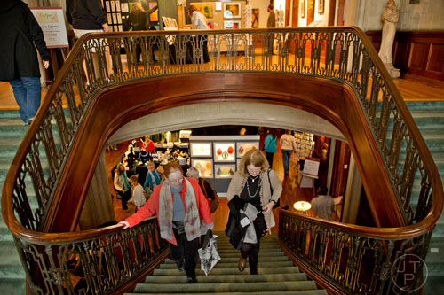Dr. Linda Norman (left) and Cindy McCreery walk up the grand staircase to look at the artwork displayed on the second floor during the Callanwolde Arts Festival in Atlanta on Saturday, January 24, 2015. 