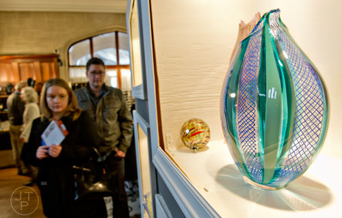 Glass art created by David Russell sits on display as Monica Wheelock and her husband Andrew pass by during the Callanwolde Arts Festival in Atlanta on Saturday, January 24, 2015. 