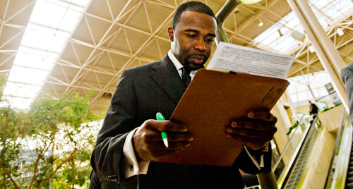 Leonard Williams fills out paperwork as he waits for the start of the 69th Atlanta Diversity, Professional, Veteran, Collegiate Career Fair at the Cobb Galleria Centre in Atlanta on Thursday, January 29, 2015.