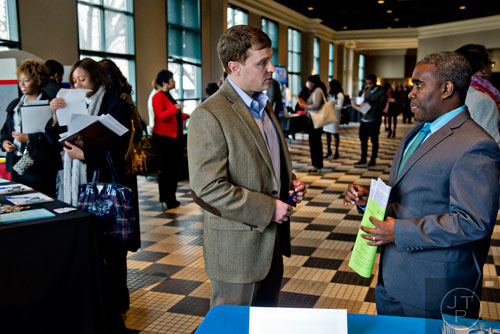 Mario Scott (right) speaks with Brent Moore as he looks for a job during the 69th Atlanta Diversity, Professional, Veteran, Collegiate Career Fair at the Cobb Galleria Centre in Atlanta on Thursday, January 29, 2015. 