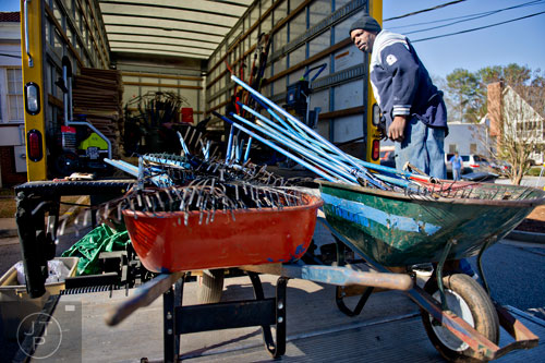 Ronnie Williams unloads wheelbarrows full of tools that will be used to make repairs during the Decatur Martin Luther King Jr. Service Project weekend on Sunday, January 18, 2015.