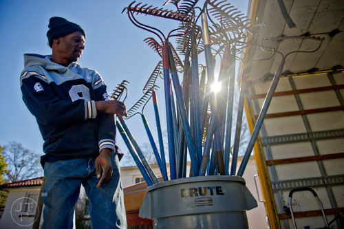 Ronnie Williams pulls out buckets of tools that will be used to make repairs during the Decatur Martin Luther King Jr. Service Project weekend on Sunday, January 18, 2015. 