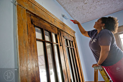 Tiffany White puts a fresh coat of paint on Annie Harper's dining room walls during the Decatur Martin Luther King Jr. Service Project weekend on Sunday, January 18, 2015. 