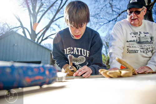 Jordan Baxter (left) and Steve Bishop prep a piece of trim as they volunteer during the Decatur Martin Luther King Jr. Service Project weekend on Sunday, January 18, 2015. 