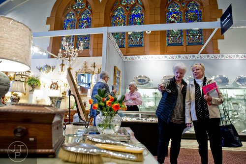 Ann Pitra (left) points out a vase to Debra Vennes as they look at different antiques during the Cathedral Antiques Show at the Cathedral of St. Philip in Atlanta on Saturday, February 7, 2015. 