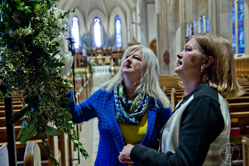 Mary Scott Harrison (left) and Louise Hoff look at a bouquet of flowers during the Cathedral Antiques Show at the Cathedral of St. Philip in Atlanta on Saturday, February 7, 2015. 