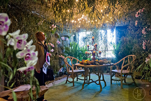 Debra Vennes looks at a room designed in a Brazilian style by Helena Harris and Melanie Millner during the Cathedral Antiques Show at the Cathedral of St. Philip in Atlanta on Saturday, February 7, 2015. 