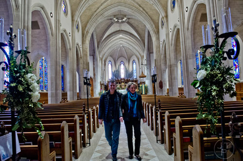 Kirk Ossewaarde (left) and his wife Anne walk down the center aisle of the santuary looking at bouquets of flowers during the Cathedral Antiques Show at the Cathedral of St. Philip in Atlanta on Saturday, February 7, 2015. 