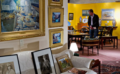 Robert Crewdson looks at different antiques during the Cathedral Antiques Show at the Cathedral of St. Philip in Atlanta on Saturday, February 7, 2015. 