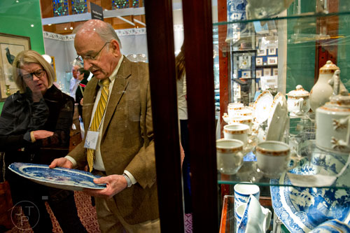 Susan Zimmerman (left) talks to Tony Scorpio about a piece of Chinese blue and white porcelain during the Cathedral Antiques Show at the Cathedral of St. Philip in Atlanta on Saturday, February 7, 2015. 