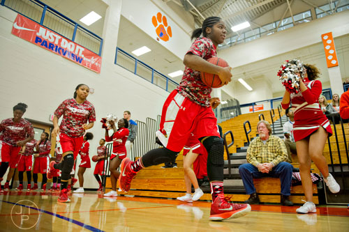 Osborne's Nikira Goings (right) leads the Cardinals onto the court to warm up for the third round of the girls state basketball championship against Parkview on Tuesday, February 24, 2015. 