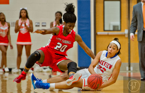 Parkview's Bernice McGriff (32) keeps control of the ball as she and Osborne's Maya Benham (20) fall to the ground during the third round of the girls state basketball championship on Tuesday, February 24, 2015.