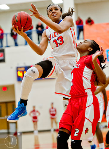 Parkview's Raven Johnson (13) goes up for two over Osborne's Zutorya Cook (2) during  the third round of the girls state basketball championship on Tuesday, February 24, 2015.  