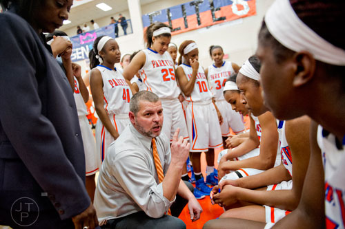 Parkview's Kirk Call (center) huddles with his team during the third round of the girls state basketball championship against Osborne on Tuesday, February 24, 2015. 