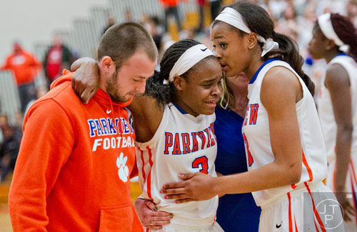 Parkview's Raven Johnson (right) checks on teammate Dominque Leonidas as she is carried off the court after injuring her ankle during the third round of the girls state basketball championship against Osborne on Tuesday, February 24, 2015.   
