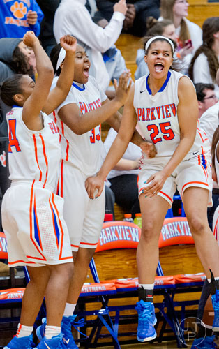 Parkview's Khari Jernigan (25), Kristi Derouen and Kristin Telford leap from their seats after defeating Osborne 73-69 in overtime for the third round of the girls state basketball championship on Tuesday, February 24, 2015.  
