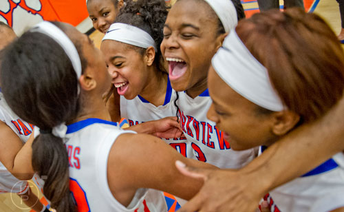 Parkview's Dominque Leonidas (center) is surrounded by teammates after defeating Osborne 73-69 in overtime for the third round of the girls state basketball championship on Tuesday, February 24, 2015.  