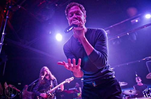 Imagine Dragons' Dan Reynolds (center) and Wayne Sermon perform on stage at Terminal West in Atlanta to a sold out show on Wednesday, February 25, 2015.  