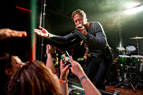 Imagine Dragons' Dan Reynolds plays up to the crowd as he performs on stage at Terminal West in Atlanta to a sold out show on Wednesday, February 25, 2015.  